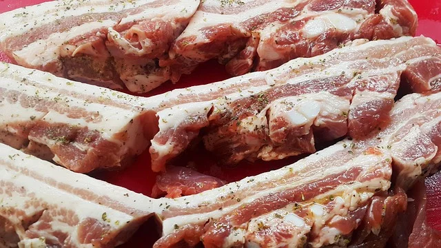 Surowy boczek wieprzowy przygotowany do peklowania i wędzenia